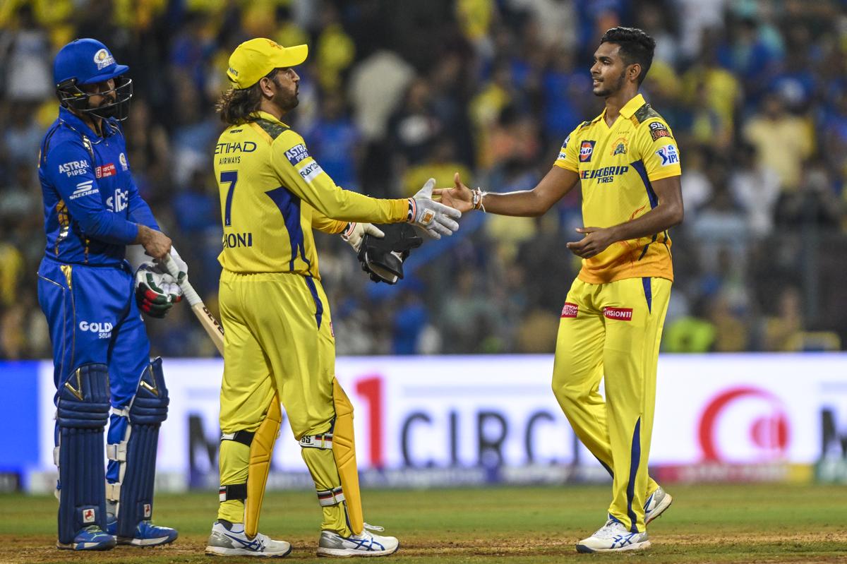 Pathirana and Dhoni celebrate a win for Chennai Super Kings against Mumbai Indians in an IPL match at the Wankhede Stadium in Mumbai.