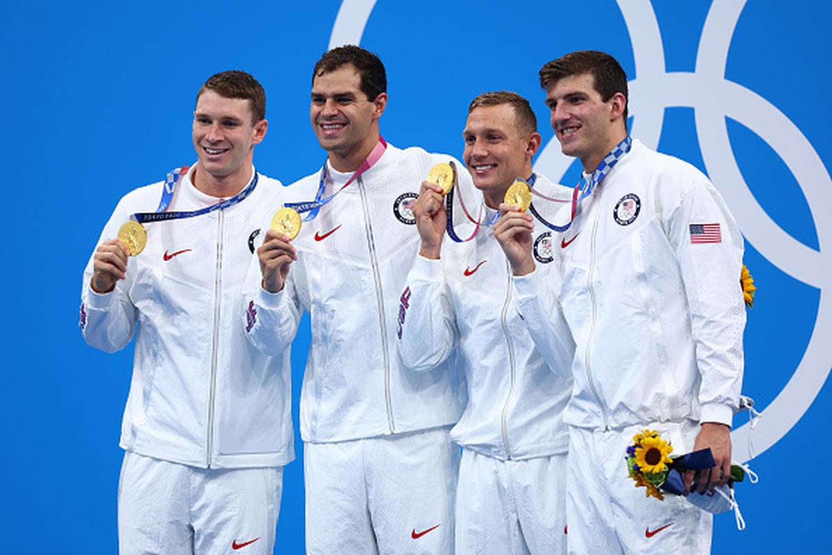 From left to right: USA’s Ryan Murphy, Michael Andrew, Caeleb Dressel and Zach Apple pose on the podium after winning the Men’s 4 x 100m Medley Relay Final on day nine of the Tokyo Olympic Games at Tokyo Aquatics Centre on August 1, 2021.