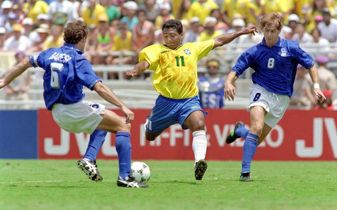 Brazilian forward Romario eyes the ball as he gets ready to shoot on goal between Italian captain and defender Franco Baresi (L) and midfielder Roberto Mussi 17 July 1994 at the Rose Bowl in Pasadena during the World Cup soccer final. Brazil won 3-2 in the shoot-out (0-0 at the end of extra time) after Roberto Baggio missed his penalty kick. 
