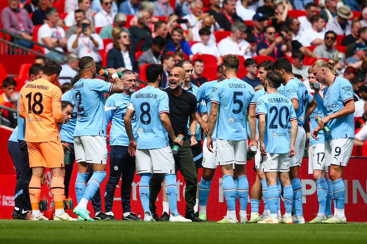 In quest of treble: Pep Guardiola talks to his Manchester City players as his team went on to complete the Premier League and FA Cup double after the win against Manchester United in the FA Cup final at Wembley Stadium on June 3, 2023.