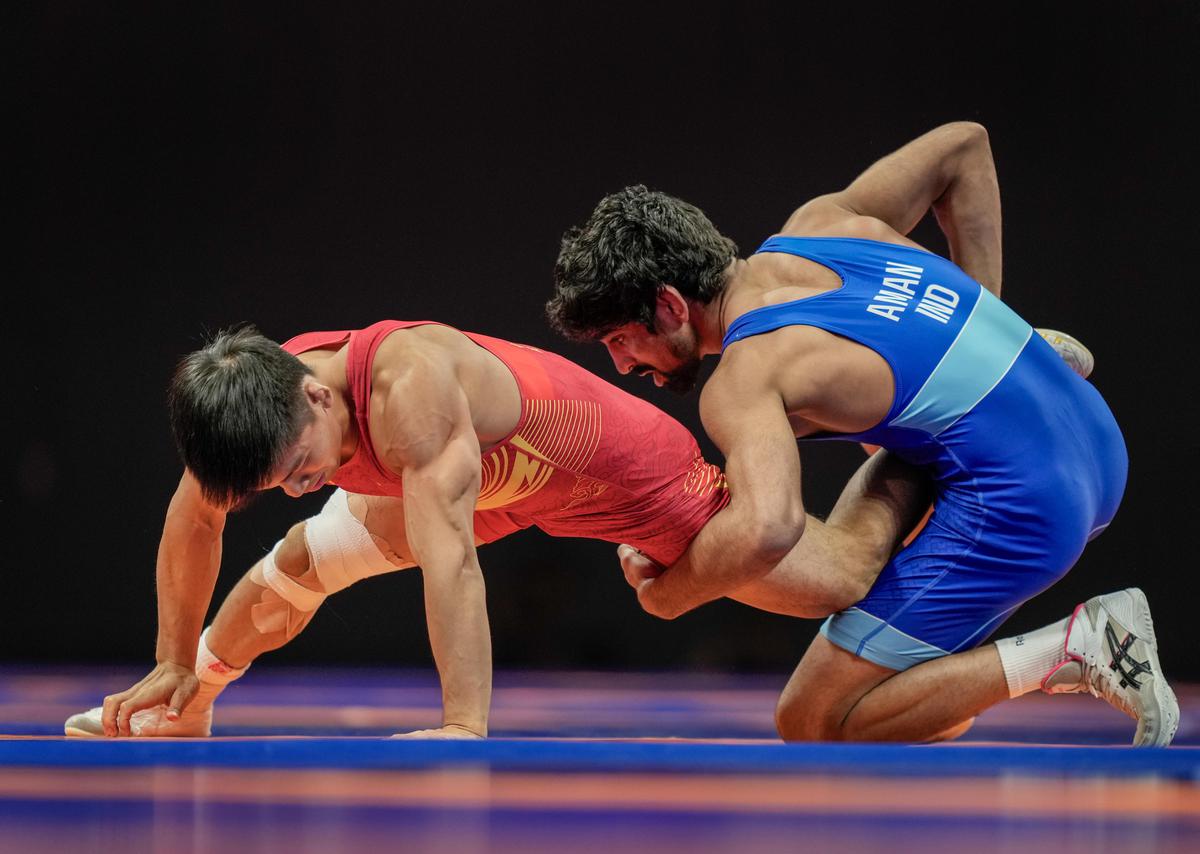 India’s Aman (in blue) beat China’s Liu Minghu in the men’s freestyle 57kg category to win the bronze medal at the 19th Asian Games, in Hangzhou, China.