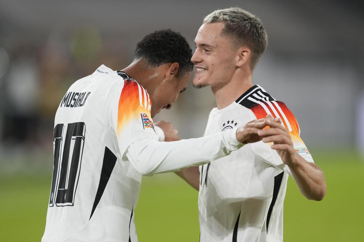 Germany’s Jamal Musiala, left, celebrates with Florian Wirtz after scoring his side’s second goal.