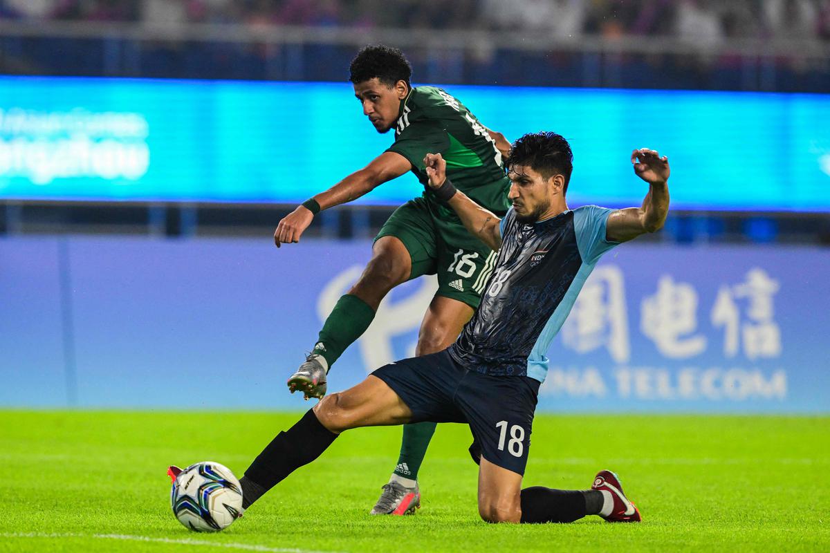 India’s Narender Gahlot (R) fights for the ball with Saudi Arabia’s Marran Mohammed Khalil in the men’s round of 16 football match during the 2022 Asian Games at the Huanglong Sports Centre Stadium in Hangzhou.