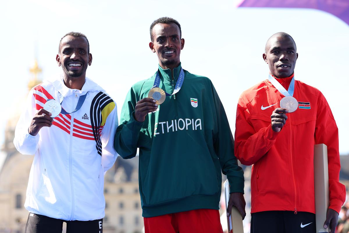 Gold medalist Tamirat Tola of Team Ethiopia (C), Silver medalist Bashir Abdi of Team Belgium (L) and Bronze medalist Benson Kipruto of Team Kenya (R).