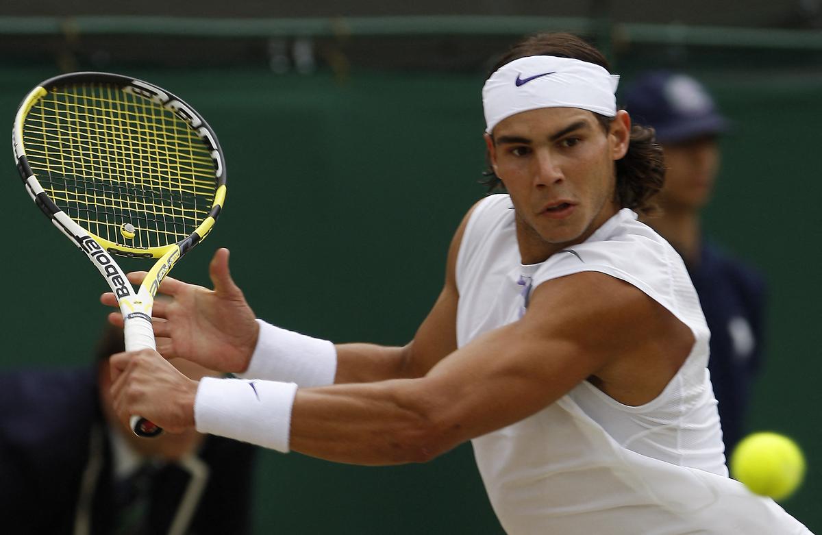 Nadal returns the ball to Russian Mikhail Youzhny during the 4th round at Wimbledon on July 5, 2007.  