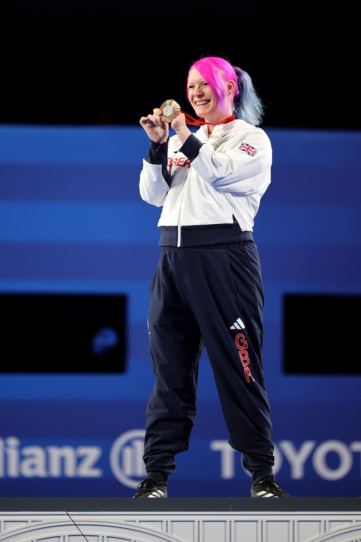 Great Britain’s Jodie Grinham celebrates on the podium after winning the bronze medal in the Para Archery Women’s Individual Compound at the Paris 2024 Paralympics. 