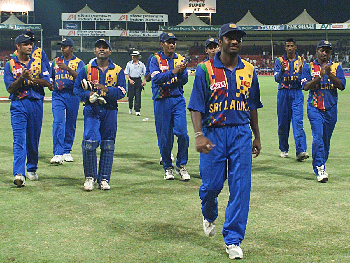 A day to remember: Muralitharan walks back with applause from teammates and the crowd after his then record performance of seven wickets against India in Sharjah.