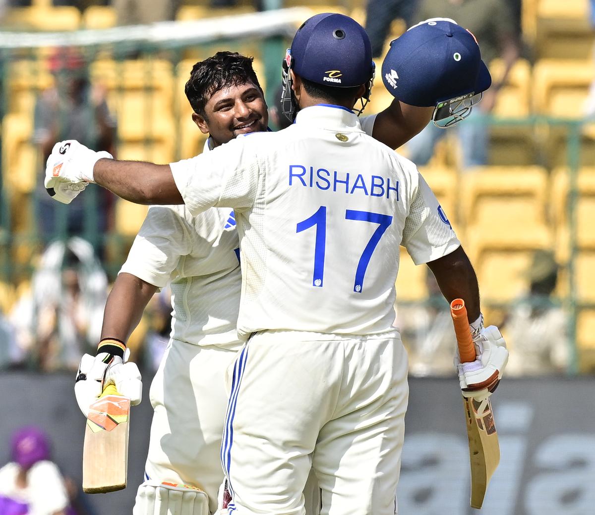 Sarfaraz greeted by Pant after he scores his century at the M. Chinnaswamy Stadium(KSCA), in Bengaluru.