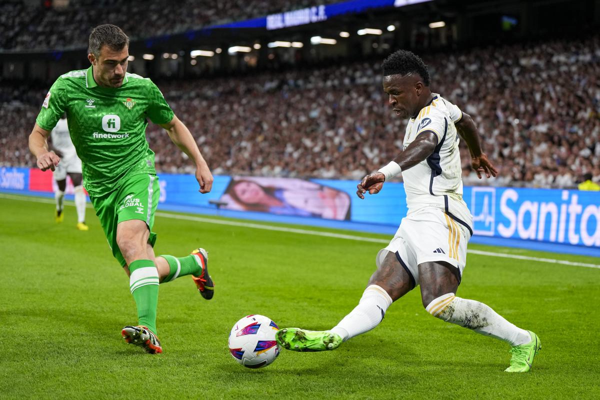 Real Madrid’s Vinicius Junior, right, vies for the ball, next to Betis’ Sokratis Papastathopoulos during a La Liga match between Real Madrid and Betis