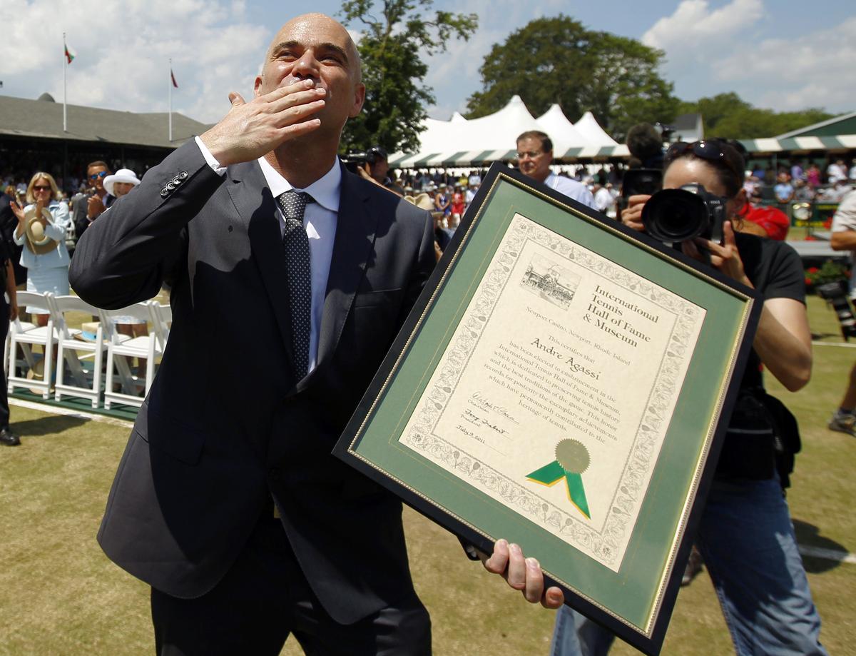 Andre Agassi blows a kiss to the crowd after being inducted into the International Tennis Hall of Fame in 2011.