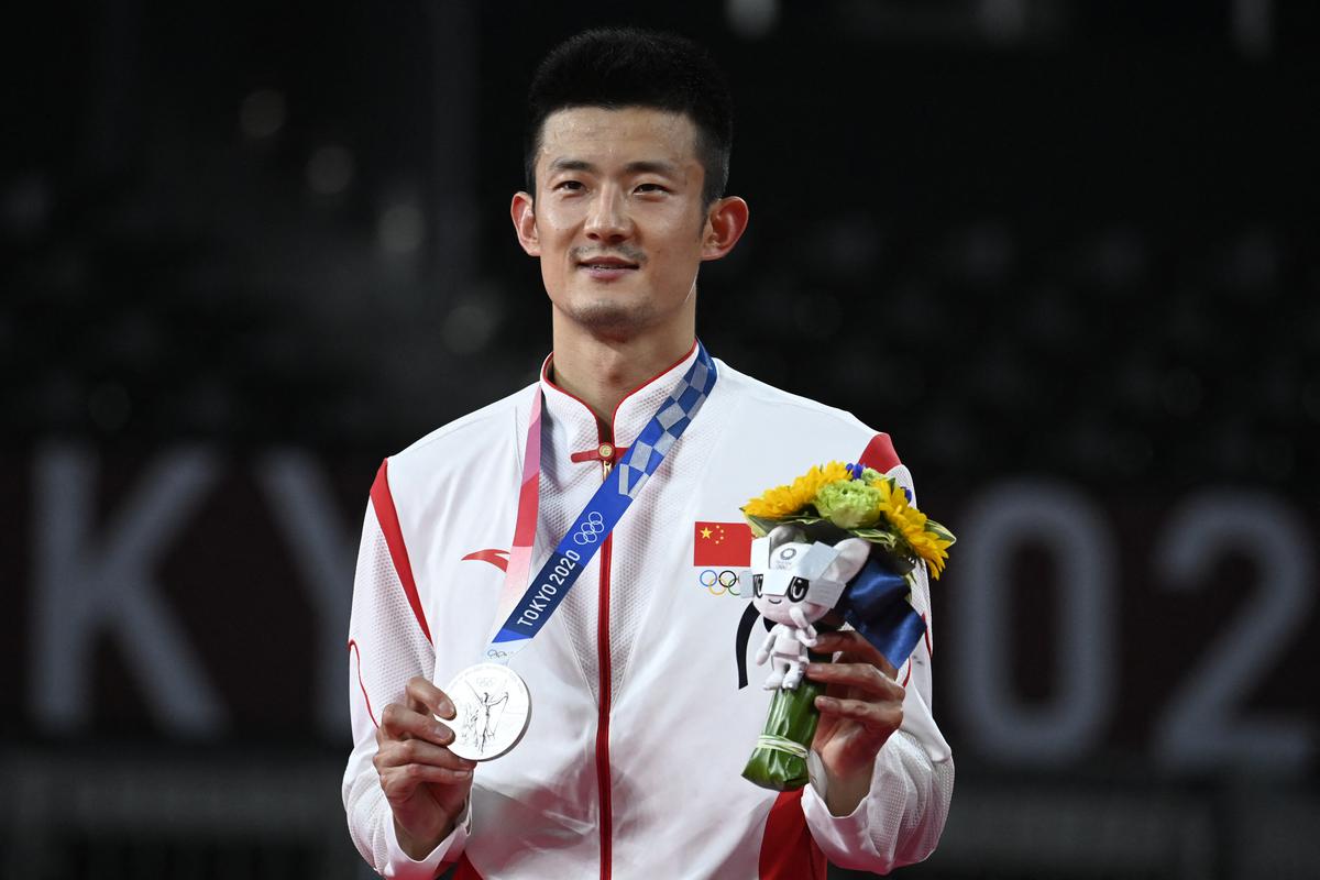 China’s Chen Long poses with his men’s singles badminton silver medal at a ceremony during the Tokyo 2020 Olympic Games at the Musashino Forest Sports Plaza in Tokyo on August 2, 2021. 