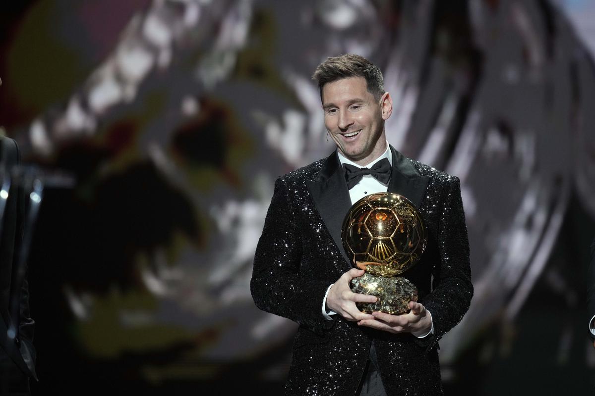 PSG player Lionel Messi reacts after winning the 2021 Ballon d’Or trophy, his seventh. 