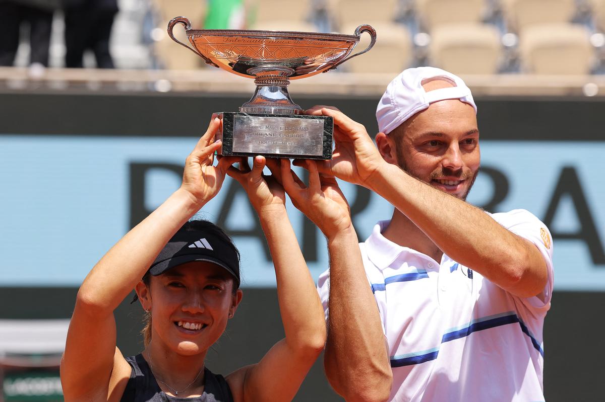 Japan’s Miyu Kato (left) and Germany’s Tim Puetz (right) with the Marcel Bernard Cup after winning mixed doubles title at French Open in 2023.