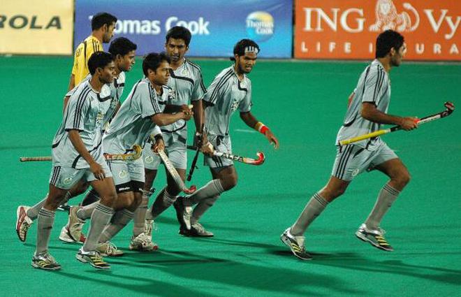 Dilip Tirkey (second from left) celebrates with his teammates during a Premier Hockey League game. 