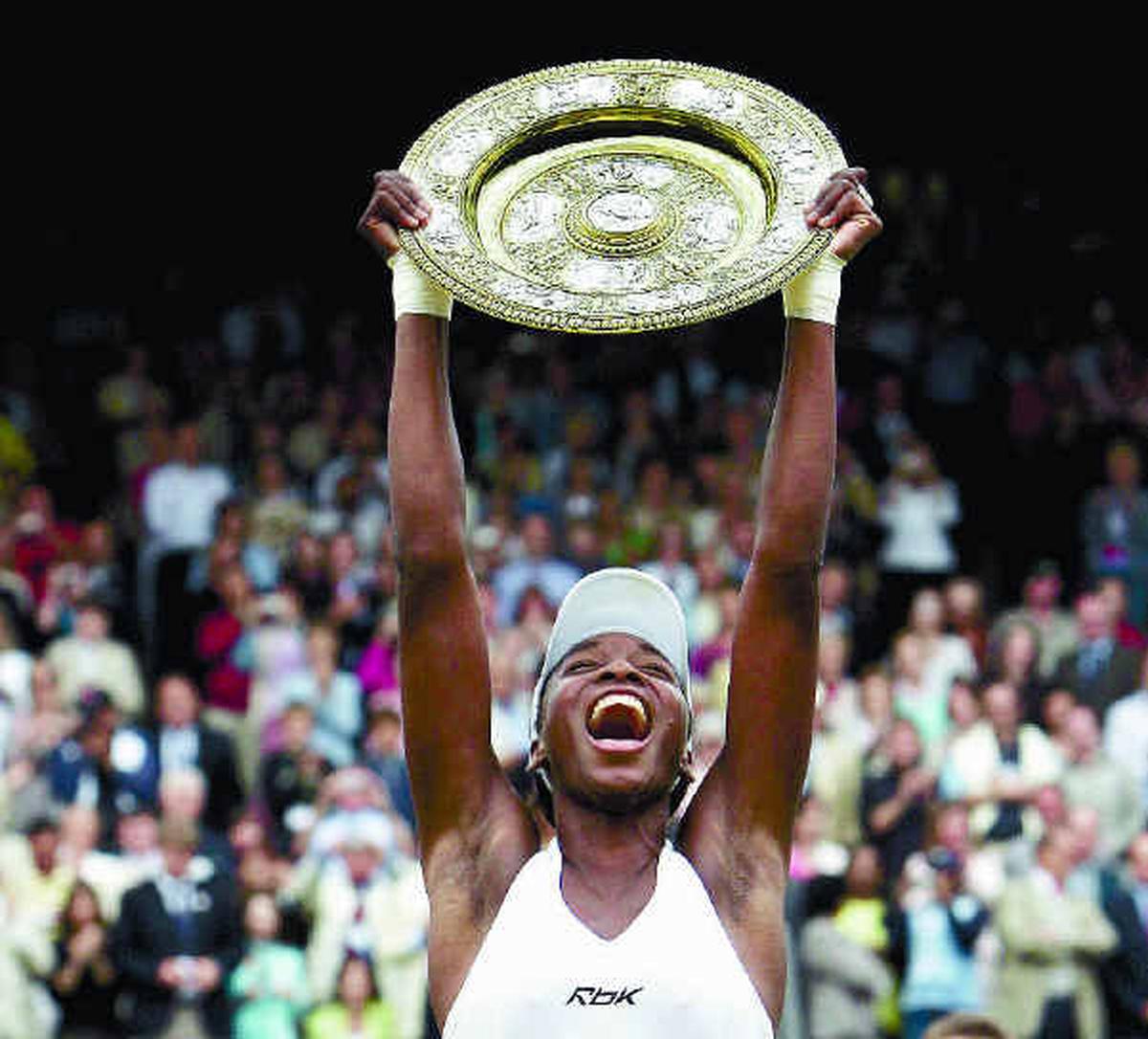 USA’s Venus Williams celebrates with the trophy after beating Lindsay Davenport in the 2005 Wimbledon final.