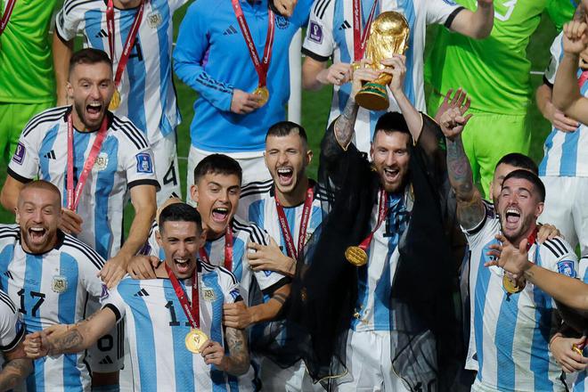 Messi lifts the World Cup trophy with his teammates.