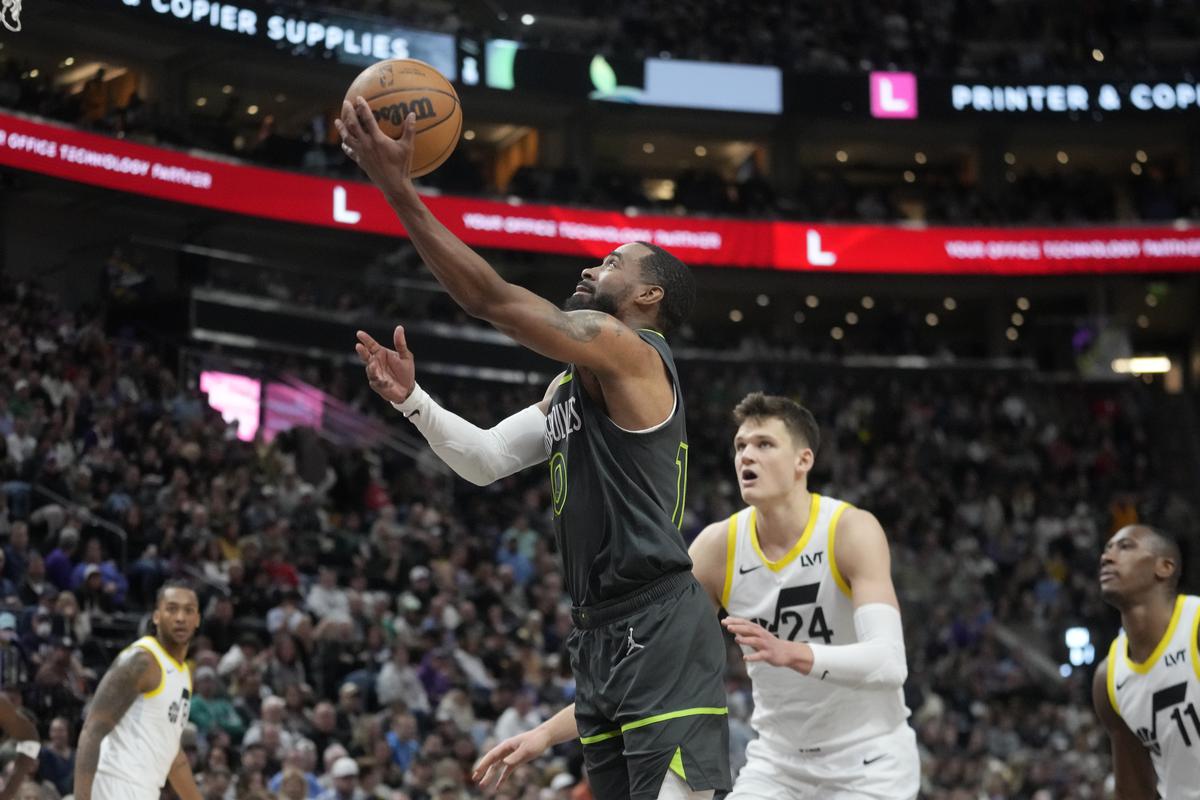 Minnesota Timberwolves guard Mike Conley goes to the basket as Utah Jazz center Walker Kessler (24) defends during the second half of an NBA basketball game.