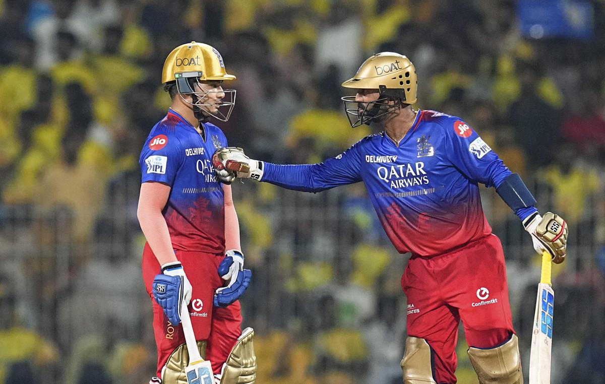 Royal Challengers Bengaluru’s batters Dinesh Karthik and Anuj Rawat during the Indian Premier League (IPL) 2024 cricket match between Chennai Super Kings and Royal Challengers Bengaluru
