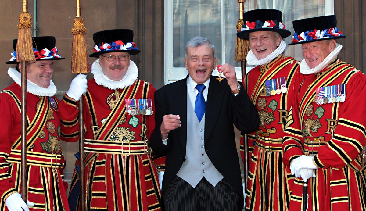 Dickie Bird beams with his OBE, awarded by Prince Charles at Buckingham Palace for services to cricket and charity.