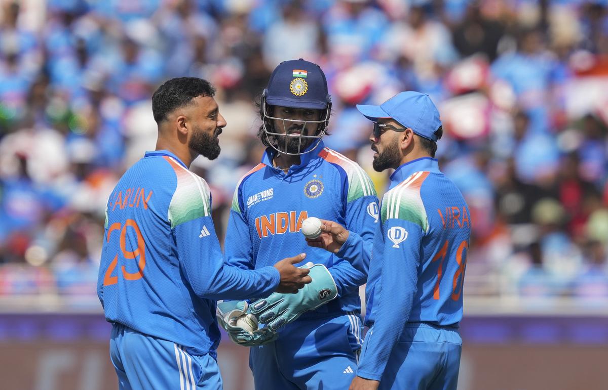 India’s Virat Kohli (R), Varun Chakaravarthy (C) and KL Rahul celebrate a wicket in the final.