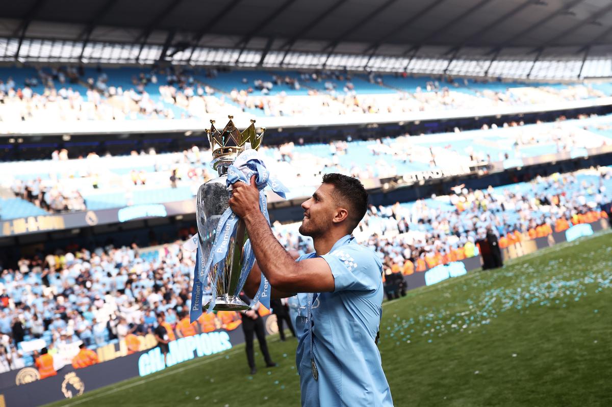 Rodri of Manchester City lifts the premier league during the Premier League match between Manchester City and West Ham United at Etihad Stadium on May 19, 2024 in Manchester, England.