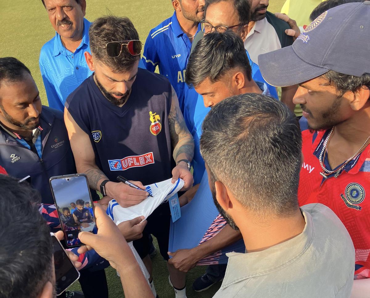 Virat Kohli obliging ball kids, ground staff, and opposition players for autographs after the end of Delhi’s Vijay Hazare Trophy match against Andhra.