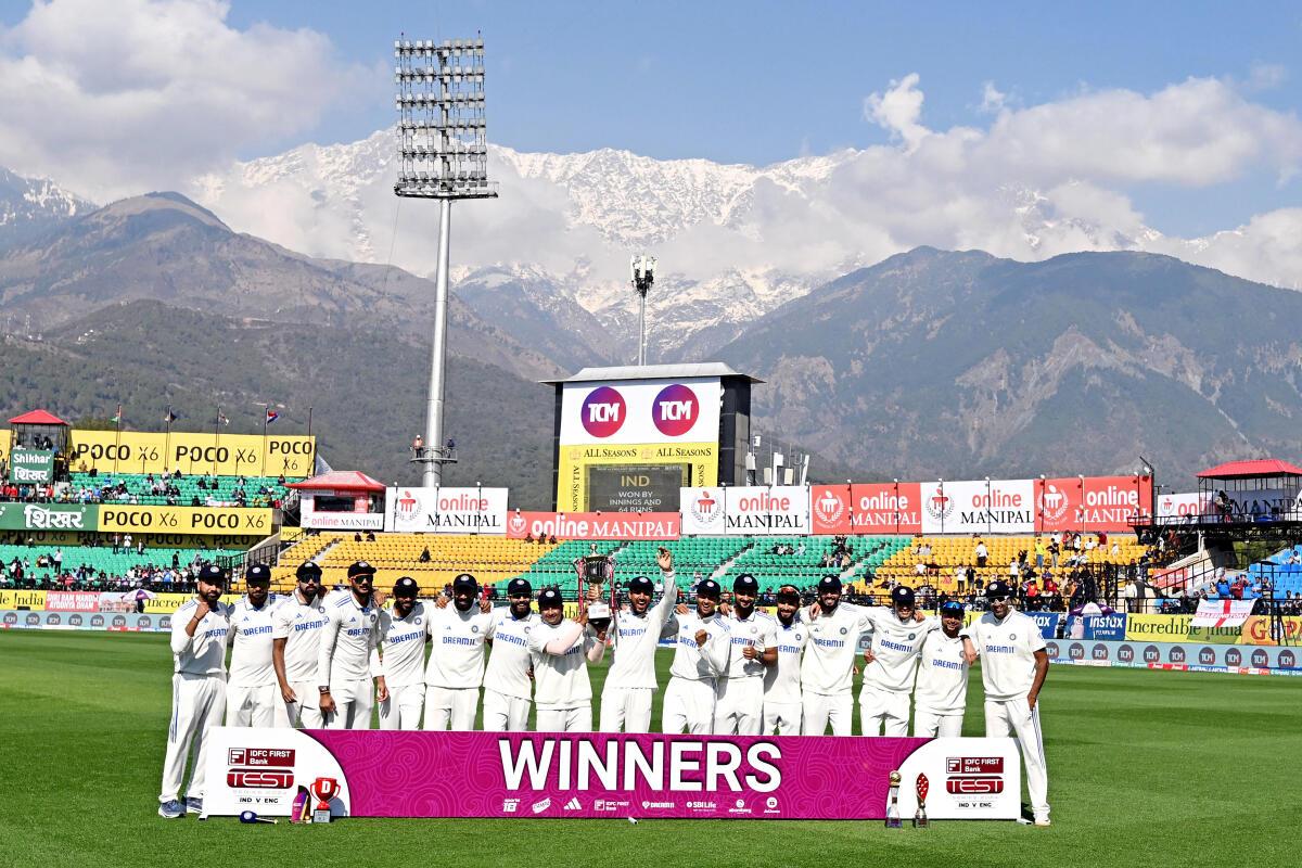 India‘s players celebrate with the trophy after winning the fifth Test match against England.