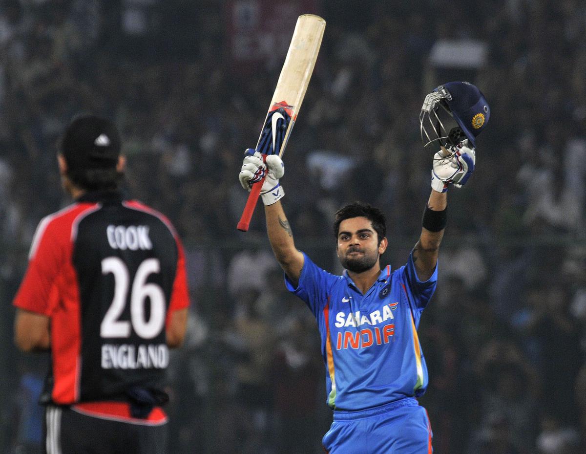 Virat Kohli celebrates after scoring a century during the second ODI match between India and England at in New Delhi on October 17, 2011.