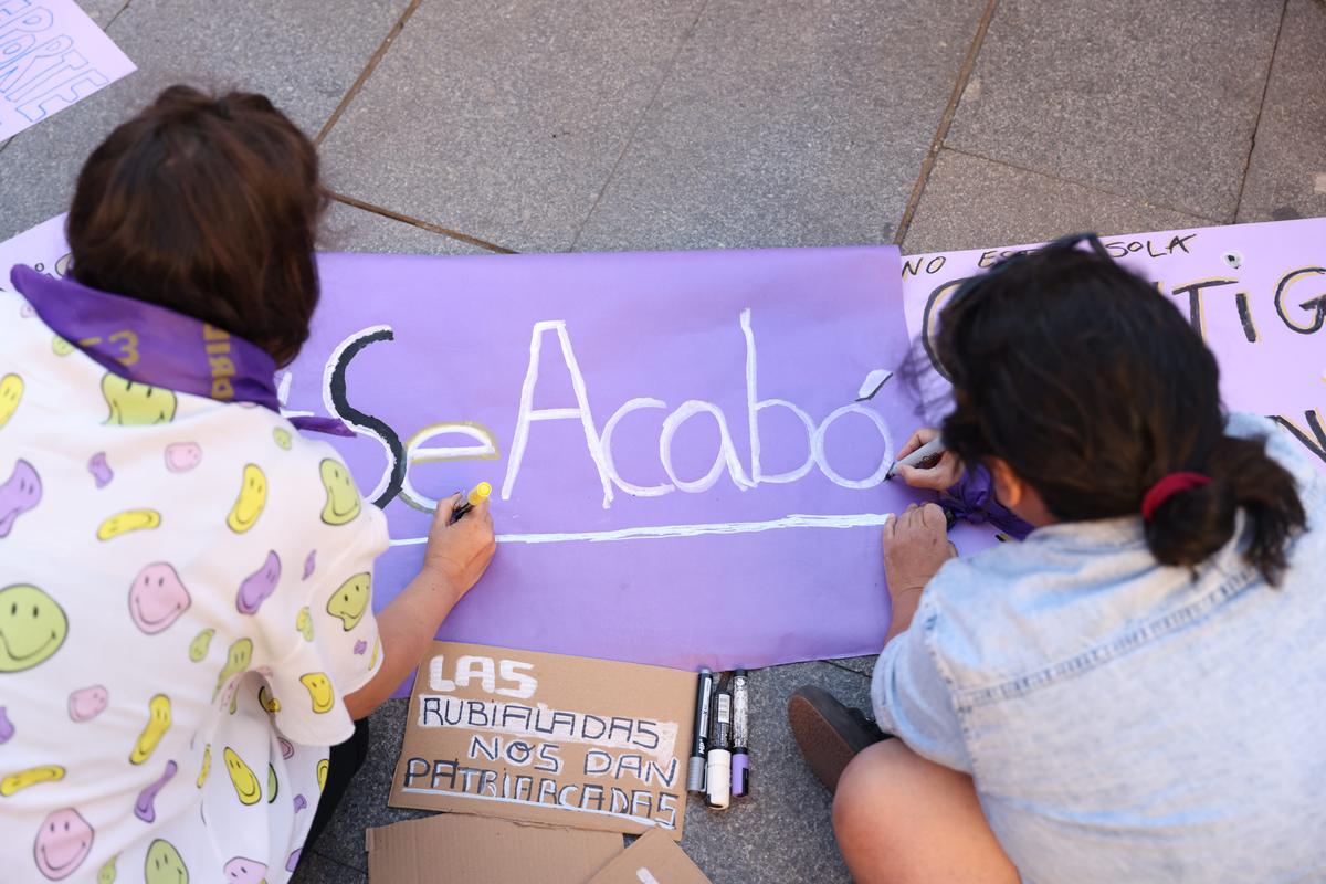Protesters paint a placard during a demonstration called by feminist associations in support to Spain’s player Jenni Hermoso, at Callao square in Madrid on August 28, 2023 in Madrid, Spain. Prompted by Luis Rubiales’ refusal to resign, protesters in Madrid are rallying against sexual violence in sport.