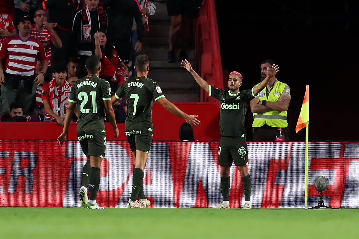 Girona players celebrate after scoring a goal. 