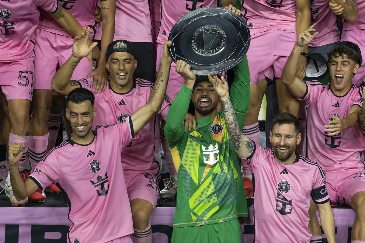 Inter Miami forward Lionel Messi (10) celebrates with his teammates Sergio Busquets (5), Luis Suárez (9) and Drake Callender (1) after winning the MLS Supporters’ Shield following their match against the New England Revolution at Chase Stadium.