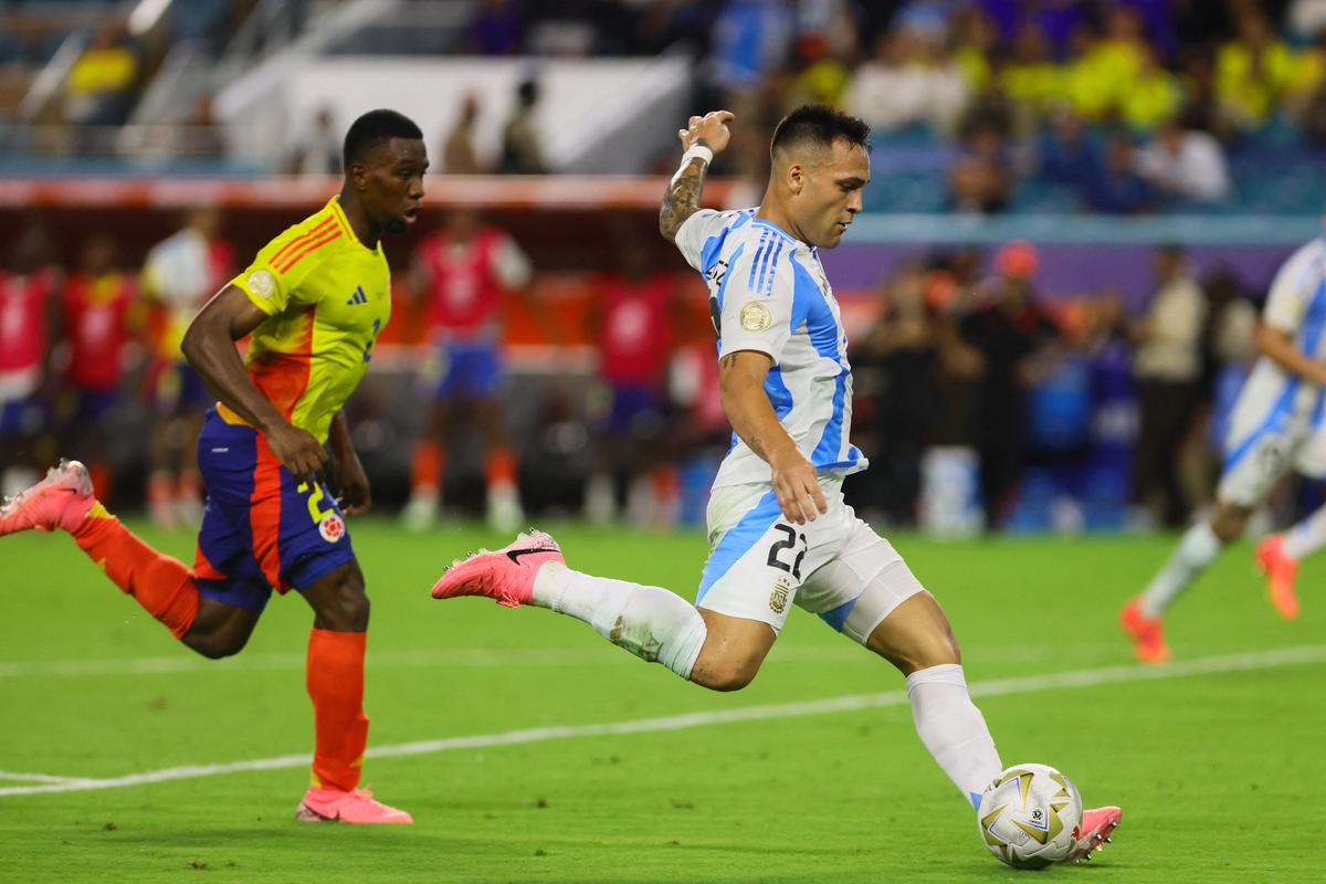 Argentina forward Lautaro Martinez shoots and scores against Colombia.