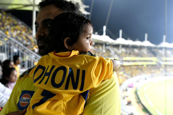 Inspiring generations: A two-month old with a Dhoni jersey at the Chepauk Stadium to watch his hero play.