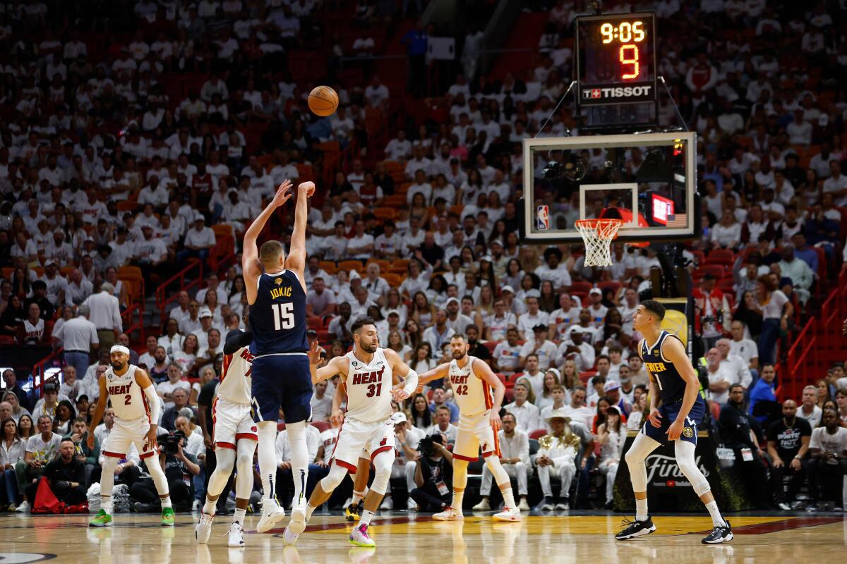 Jokic scores a three-pointer against Heat in the NBA finals.