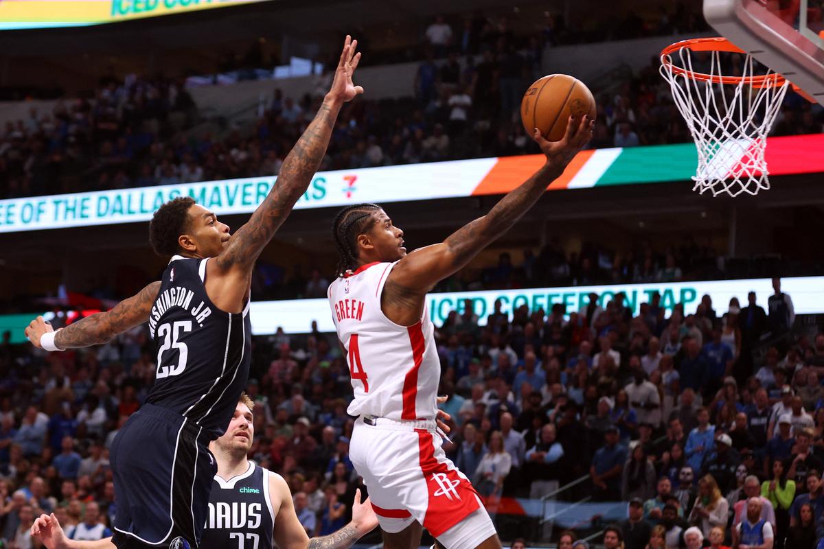 P.J. Washington #25 of the Dallas Mavericks tried to defend against a shot by Jalen Green #4 of the Houston Rockets.