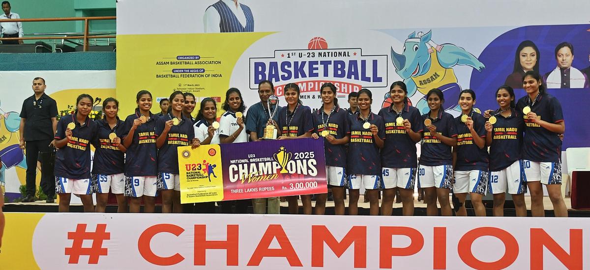 The Tamil Nadu women’s team posing with the winners’ trophy at the National under-23 basketball championships in Guwahati on Monday.