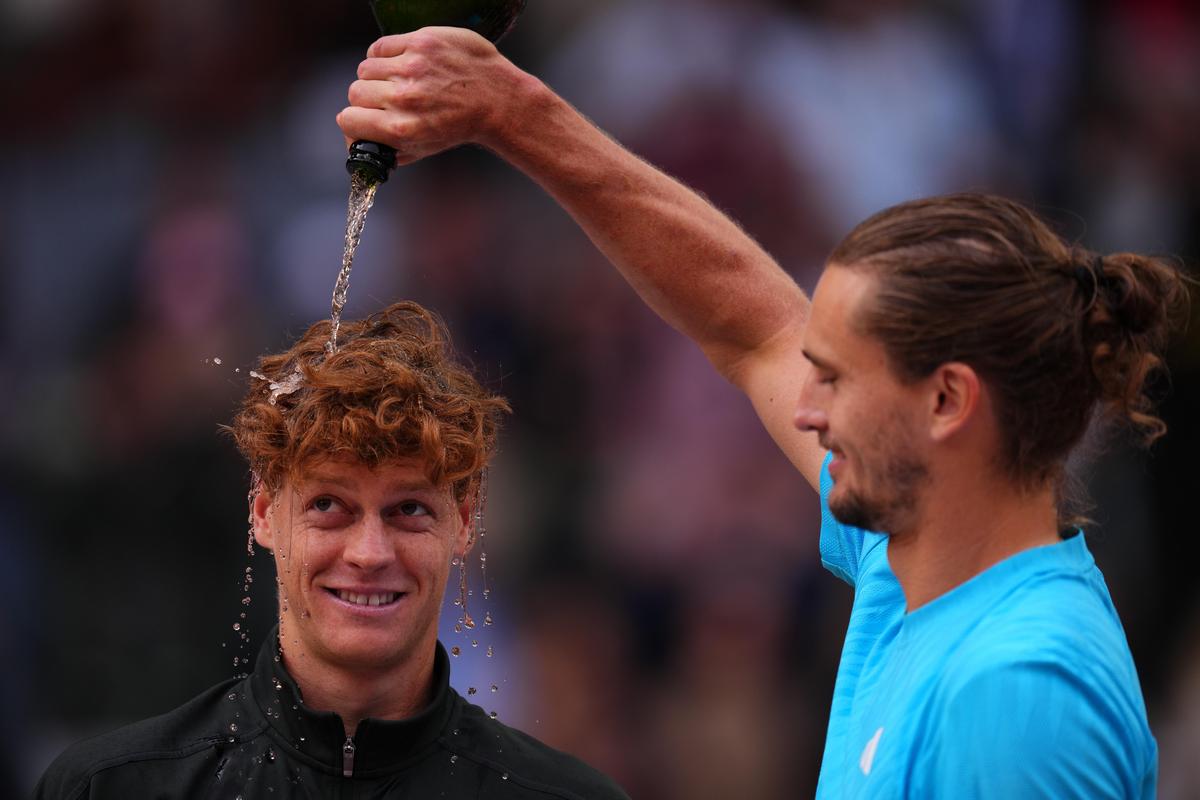 Alexander Zverev, da Alemanha, à direita, derrama vinho espumante na cabeça do italiano Jannik Sinner no Aberto de Madrid, em 3 de maio.