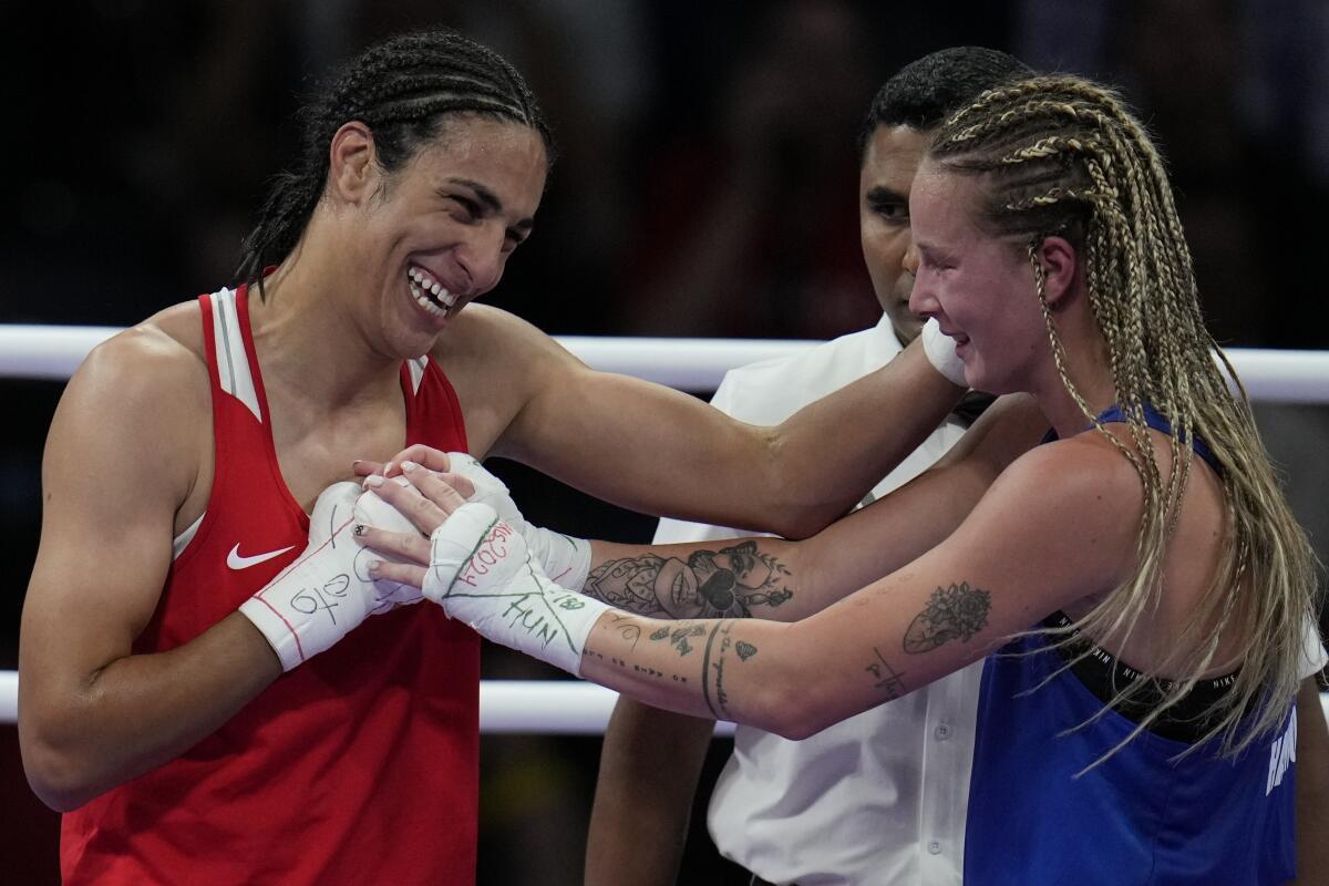 Algerian boxer Imane Khelif with Hungary’s Luca Anna Hamori after their quarterfinal bout in the Paris Olympics. 