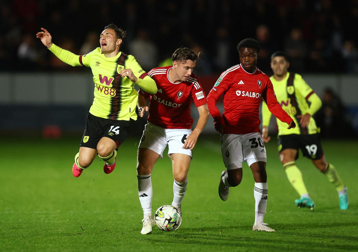 Burnley’s Connor Roberts in action with Salford City’s Elliot Watt and Kelly N’Mai. 