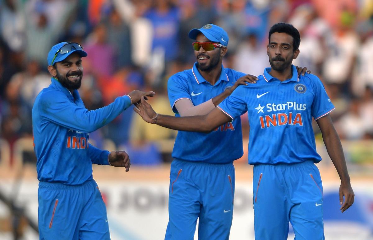 Dhawal Kulkarni (right) celebrates with teammates Hardik Pandya and Virat Kohli after taking a wicket against New Zealand in a One Day International at the JSCA stadium in Ranchi.