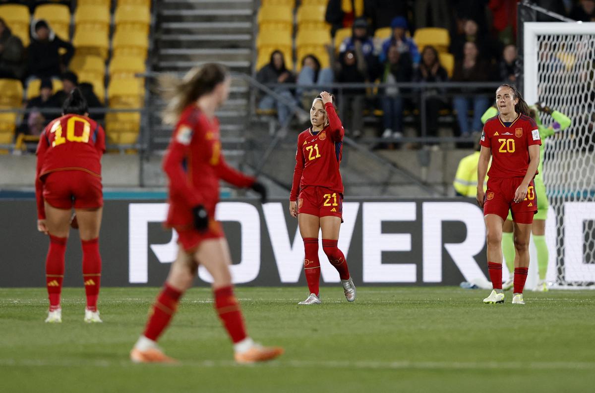 Spain players look dejected after losing to Japan. 