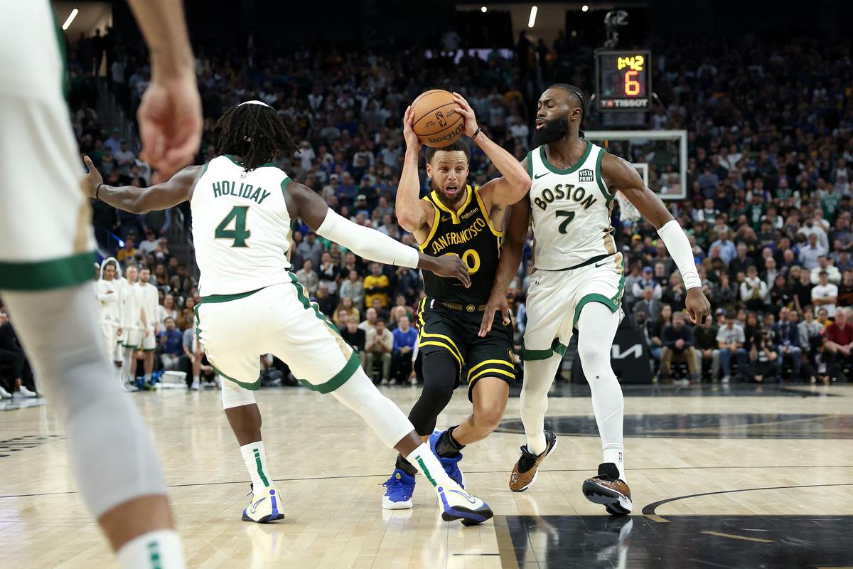 Stephen Curry #30 of the Golden State Warriors is guarded by Jaylen Brown #7 of the Boston Celtics at Chase Center on December 19, 2023 in San Francisco, California. 