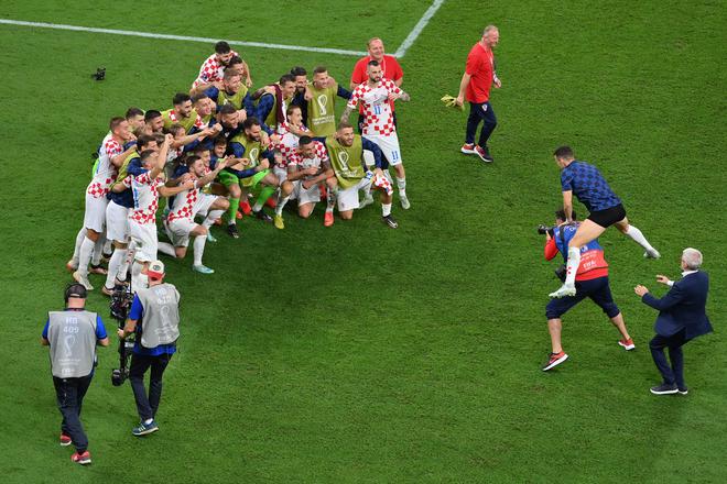 Croatia players celebrate after the team’s qualification to the knockout stages after beating Belgium in their final group match. 