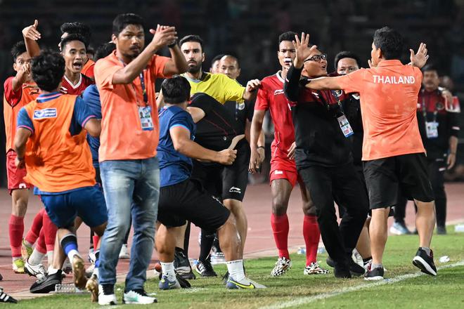 Players and officials react as a fight breaks out on the sidelines of the men’s football final match between Thailand and Indonesia during the 32nd Southeast Asian Games (SEA Games) in Phnom Penh.