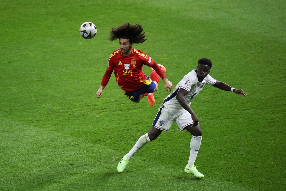 Cucurella wins a header against Saka in the Euro 2024 final.