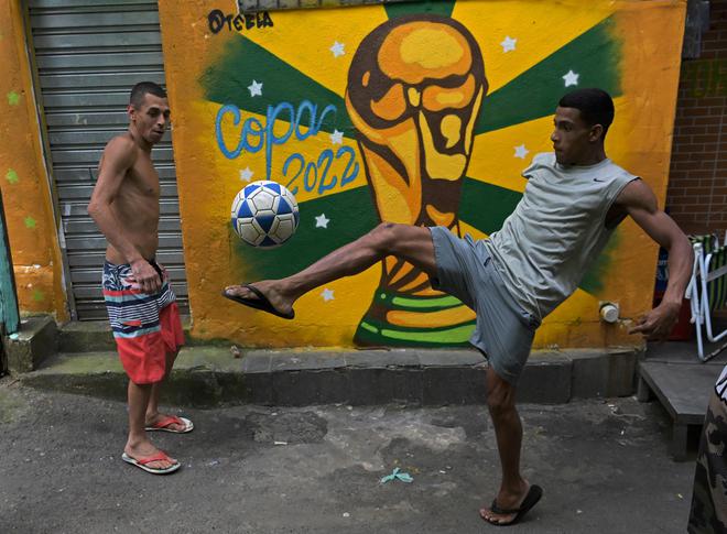 Residents play football in a street in Rocinha favela, Rio de Janeiro.