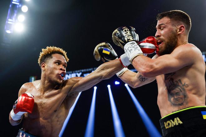 Devin Haney punches Vasyl Lomachenko of Ukraine during their undisputed lightweight title bout at MGM Grand Garden Arena. 