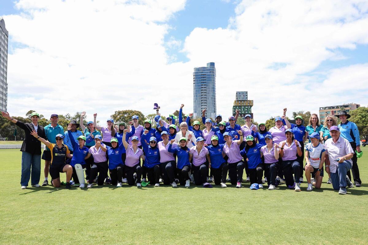 Players from both teams pose for a photo with Australian Governor-General Sam Mostyn (C) during the cricket match between Afghanistan Women’s XI and Cricket Without Borders XI at Junction Oval in Melbourne on January 30, 2025.