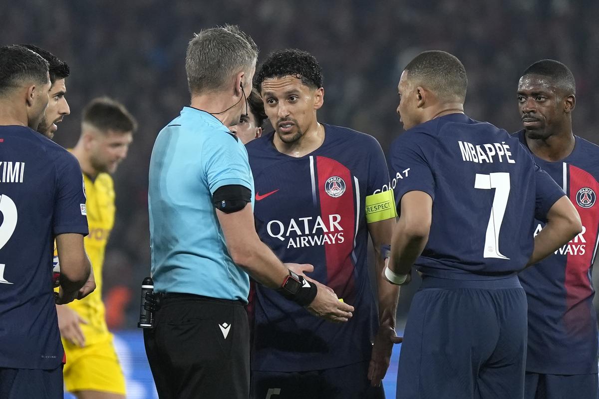 PSG’s Marquinhos, centre, argues with referee Daniele Orsato during the Champions League semifinal second leg against Borussia Dortmund.