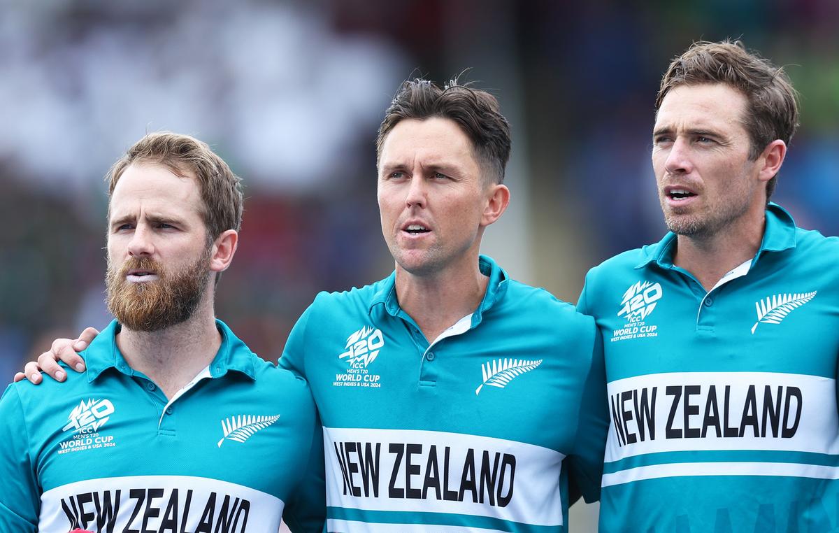 Kane Williamson, Trent Boult and Tim Southee of New Zealand line up for the National Anthems ahead of the match against PNG. 